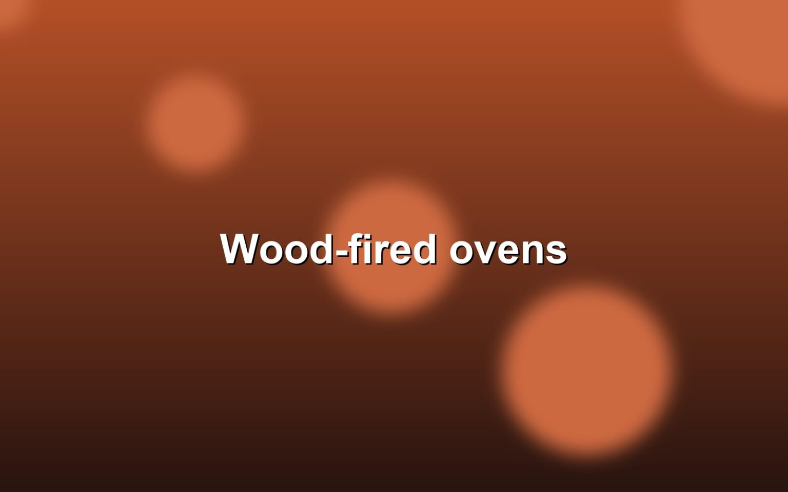 The wood-fired ovens glowing at the back of the bakery